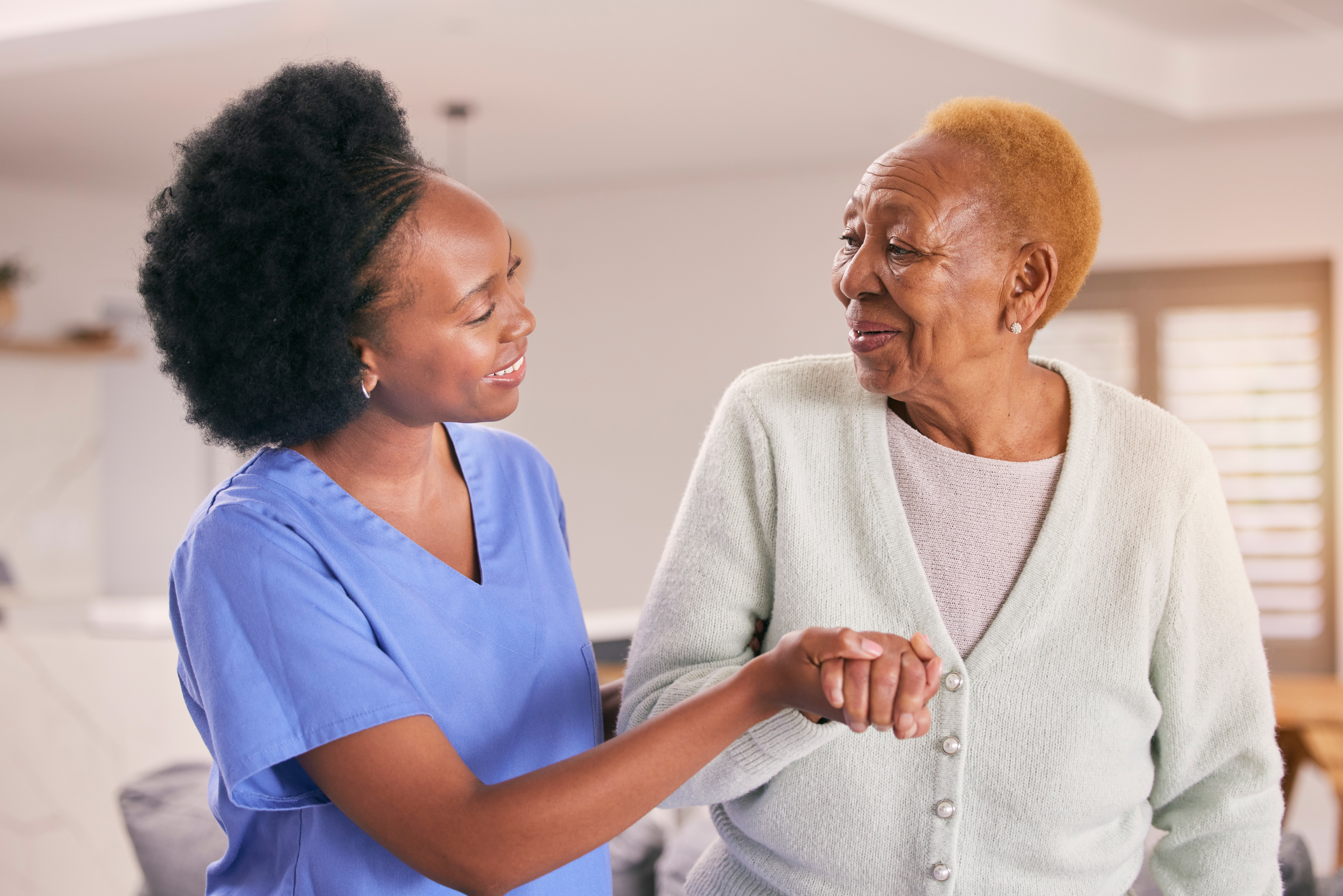 Caregiver helping a senior woman with daily activities